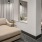 a room with large chairs and side tables