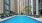 a swimming pool in a courtyard between buildings