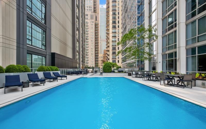 a swimming pool in a courtyard between buildings