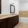 a bathroom with a tub, sink and mirror