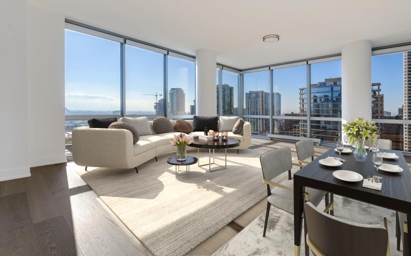 living and dining areas with city views from floor-to-ceiling windows