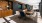 a room with tables, chairs and a tv