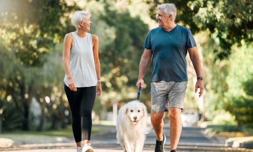 A beautiful community at the heart of all your passions A couple walking their dog outside
