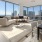 living and dining areas with city views from floor-to-ceiling windows