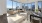 living and dining areas with city views from floor-to-ceiling windows